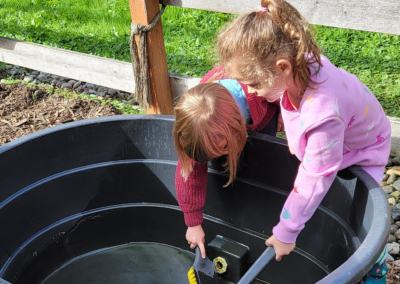 Village Learning children cleaning the horses water tank