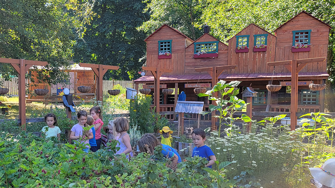View larger image of children in the garden in front of the village Children in the garden in front of the village