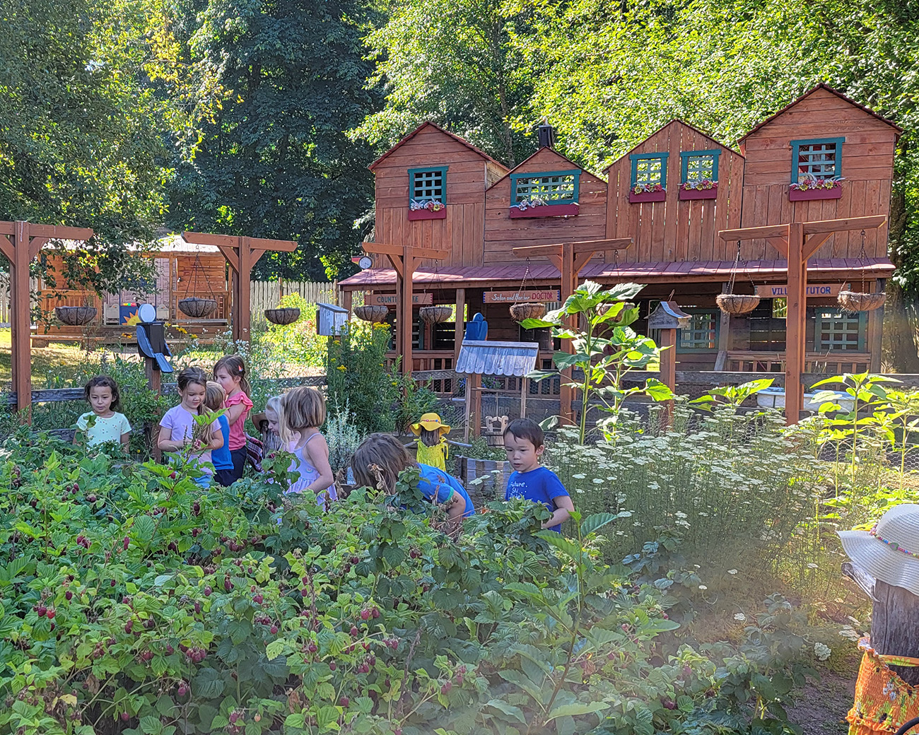 View larger image of children in the garden in front of the village Children in the garden in front of the village